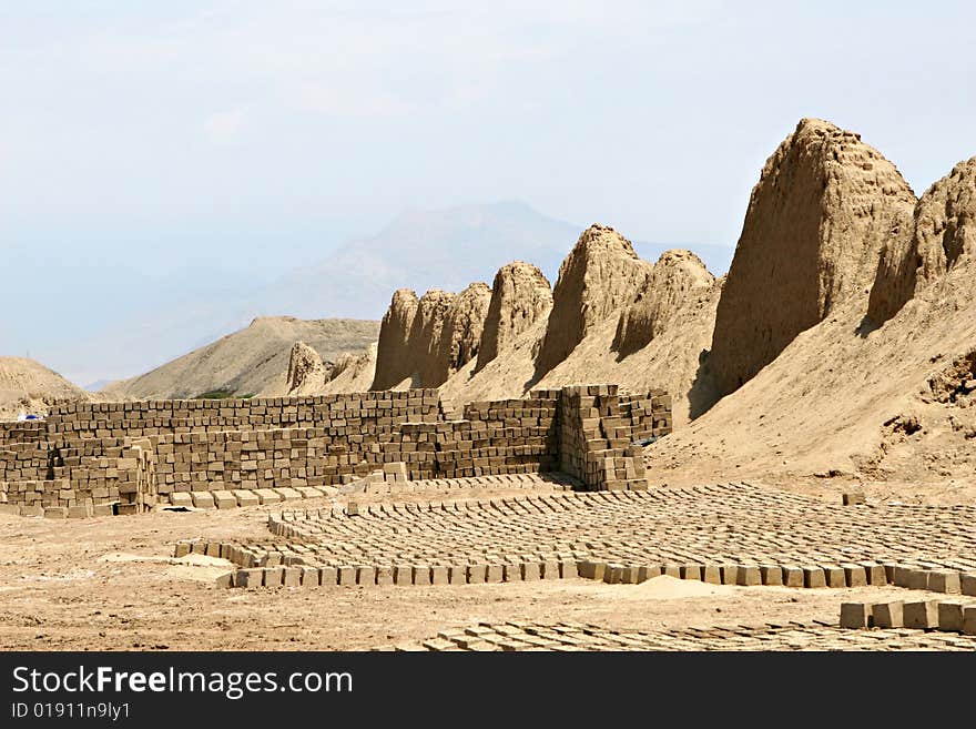 Hundred of traditionally made mud bricks are layed out in the hot desert sun to dry. Hundred of traditionally made mud bricks are layed out in the hot desert sun to dry