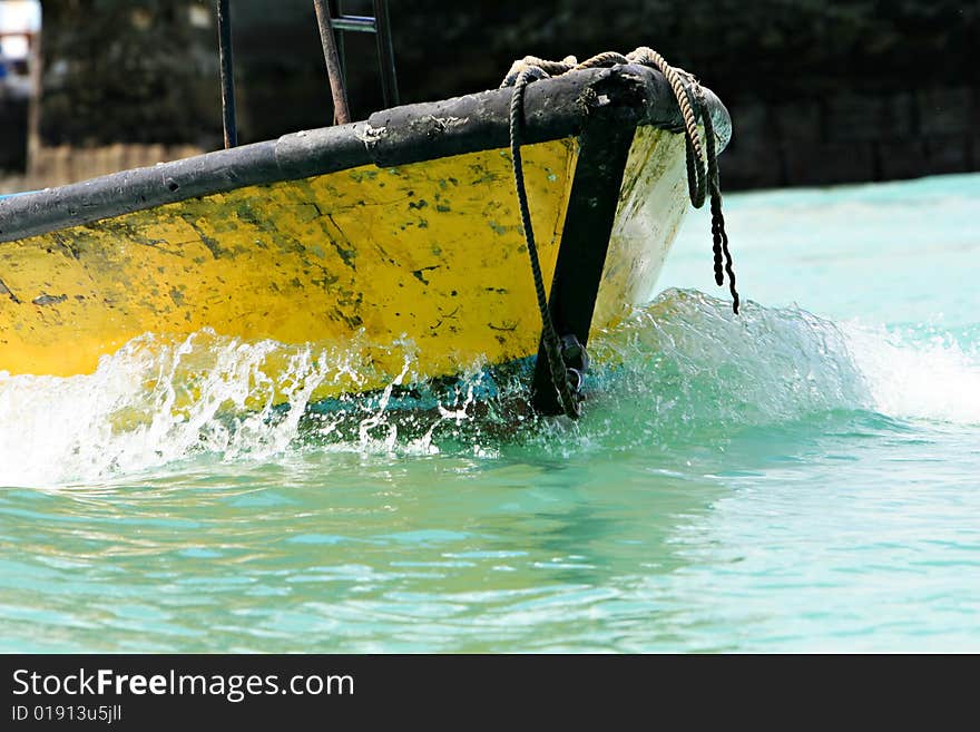 A Small Yellow Boat in Motion