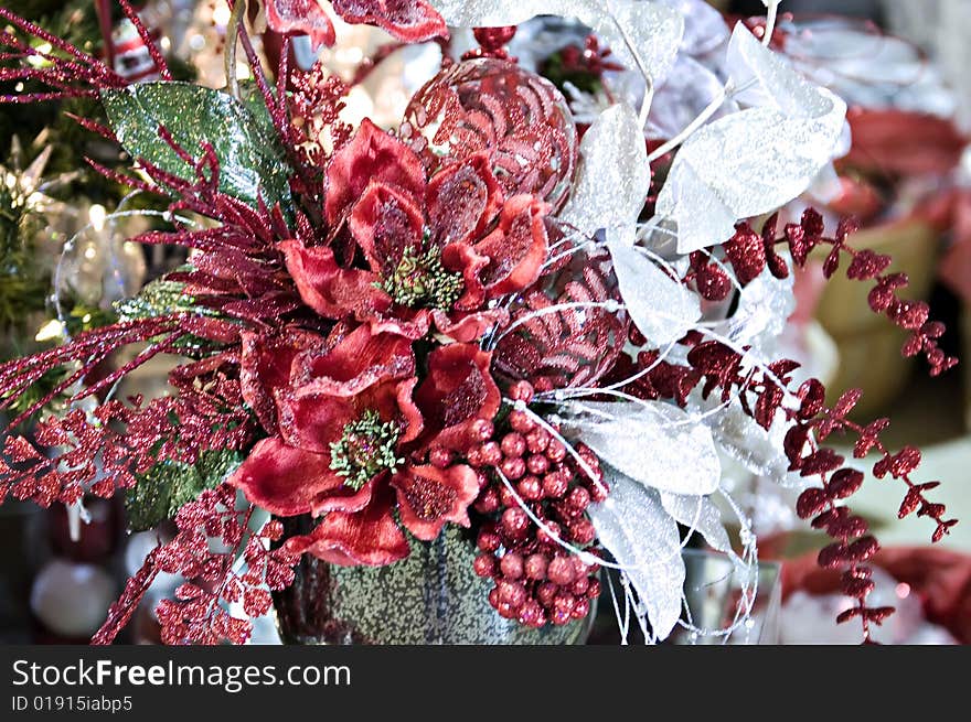 A christmas arrangement with lots of glitz and a poinsetta. A christmas arrangement with lots of glitz and a poinsetta