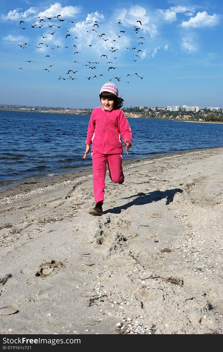 Running child on river shore