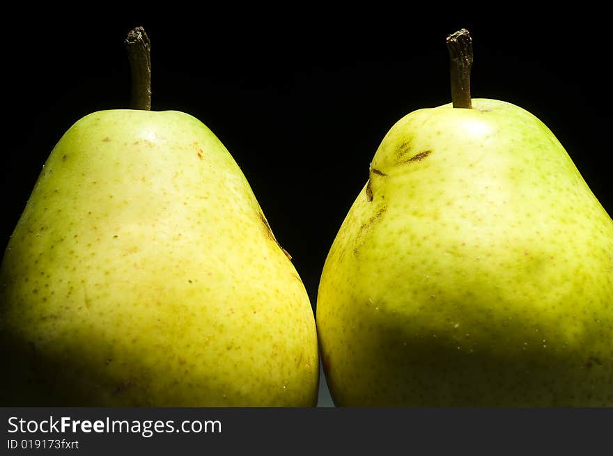 Two pears isolated on black background. Two pears isolated on black background