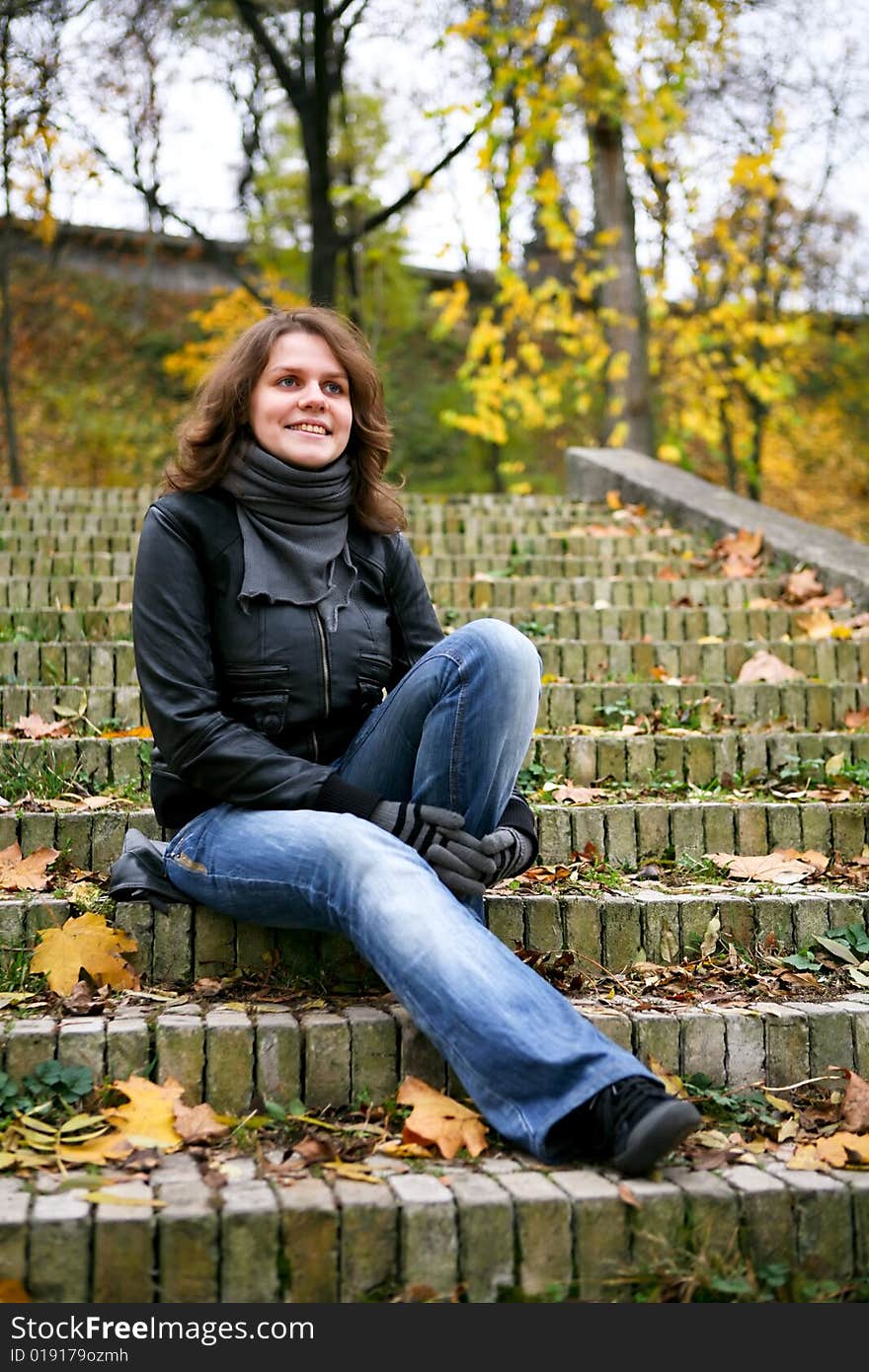 Smiling beauty woman sit on the stairs. Smiling beauty woman sit on the stairs