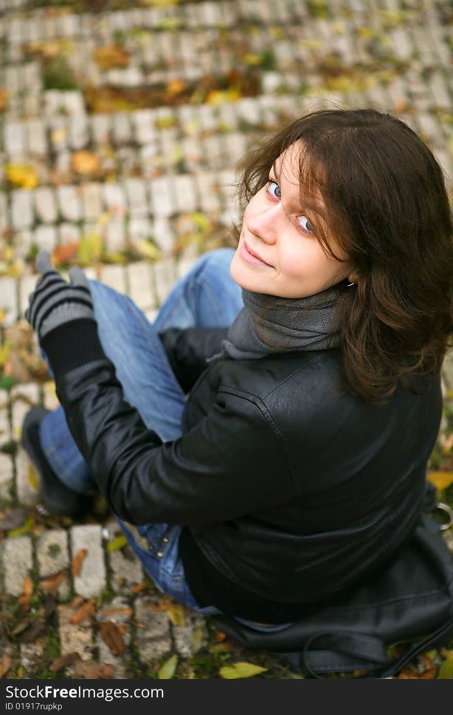 Woman sit on the stairs. Autumn