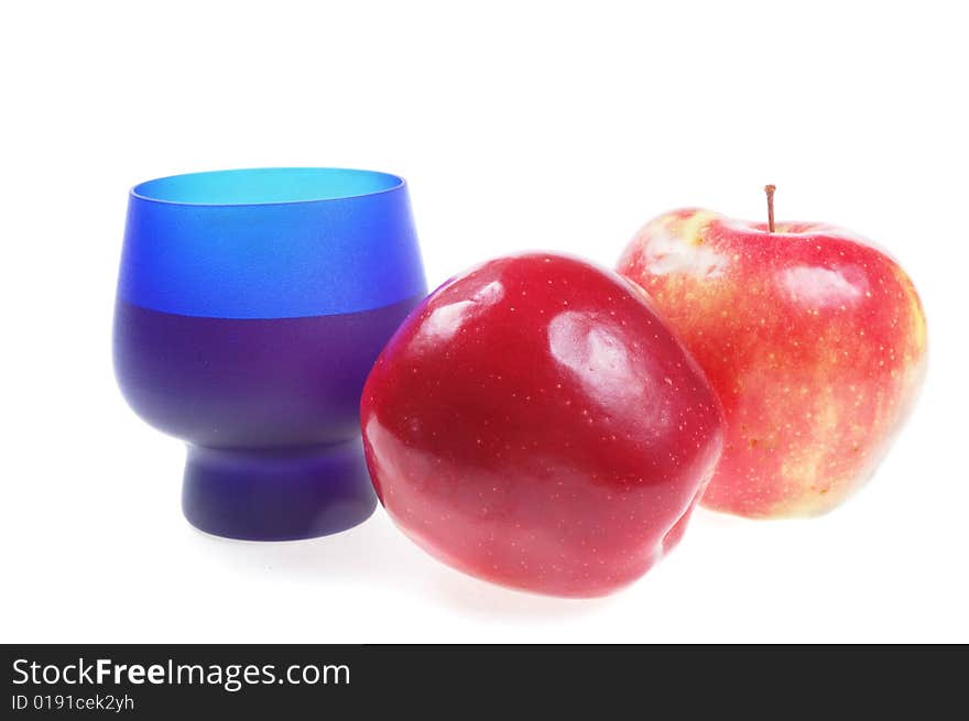 Two ripe red apple with blue glass. Two ripe red apple with blue glass