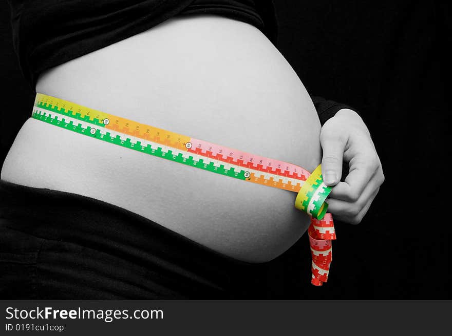 Pregnant woman measuring her stomach. Pregnant woman measuring her stomach