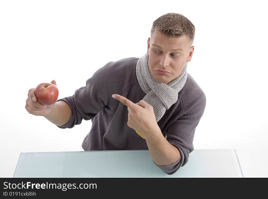 Young male pointing the apple