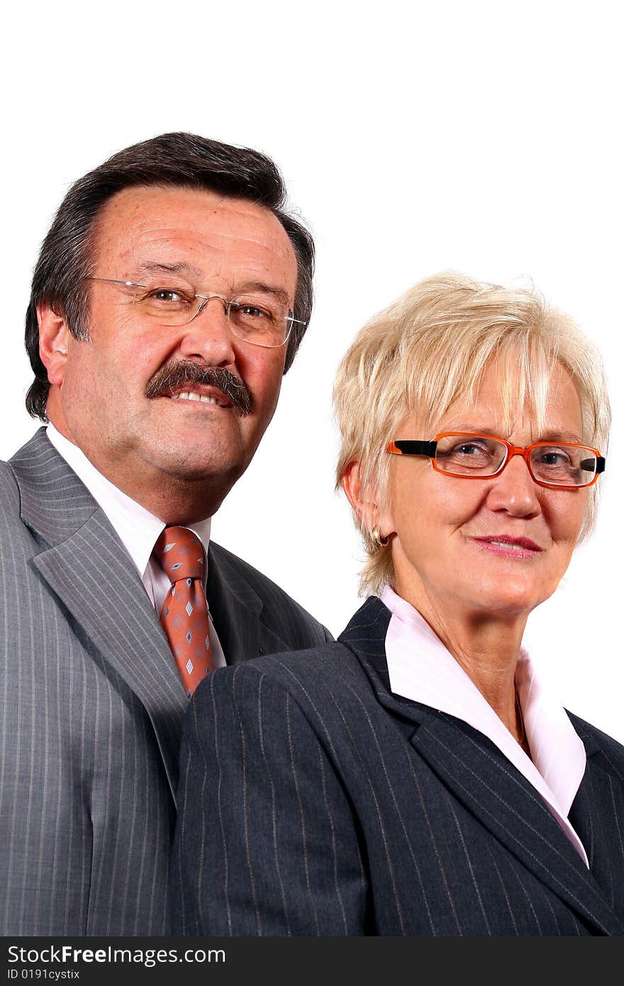 A senior business couple in suits in their 50s and 60s. Isolated over white. A senior business couple in suits in their 50s and 60s. Isolated over white.