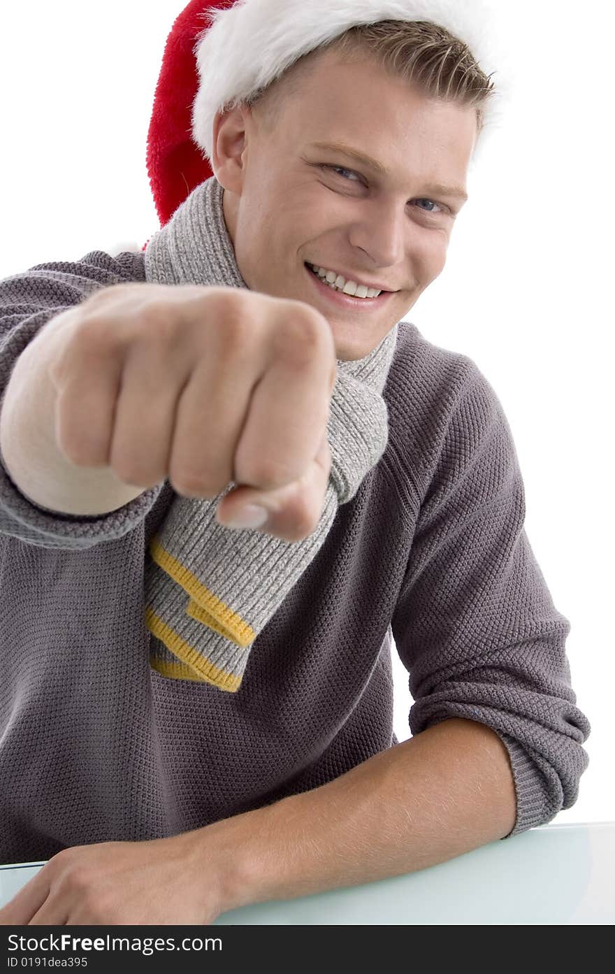 Smiling young man with christmas hat showing punch