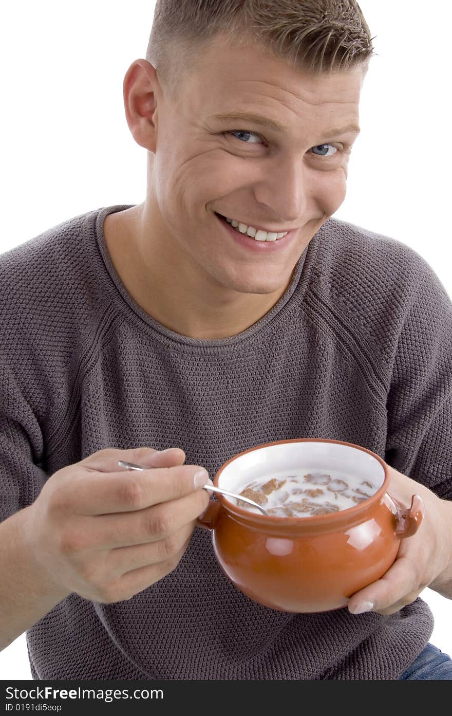 Portrait of smiling male going to eat cornflakes with white background