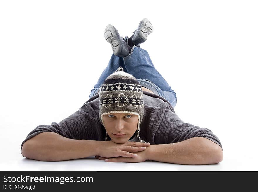 Laying young man wearing winter cap on an isolated white background