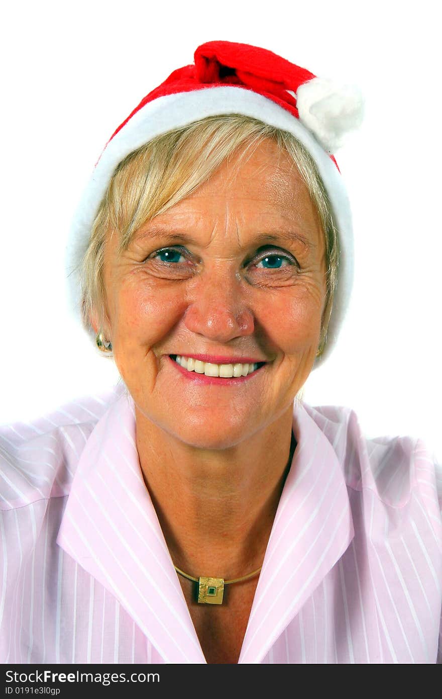 A businesswoman in her sixties with a Santa claus hat - smiling. Isolated over white. A businesswoman in her sixties with a Santa claus hat - smiling. Isolated over white.