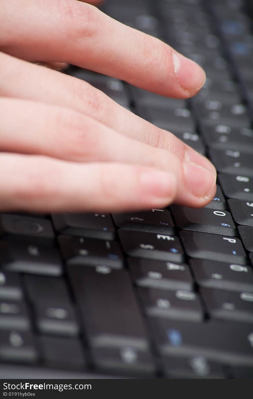 Black computer keyboard with black buttons with fingers