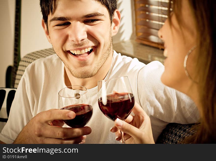 Happy young couple drinking wine