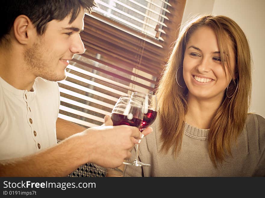 Happy young couple drinking wine