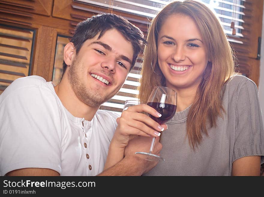 Happy young couple drinking wine