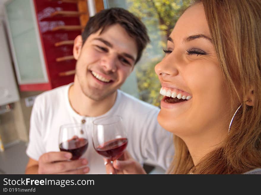 Happy young couple drinking wine