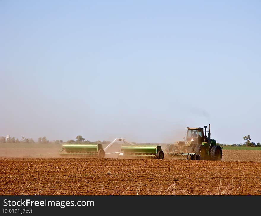 Farmer preparing the soil and sowing seed. Farmer preparing the soil and sowing seed