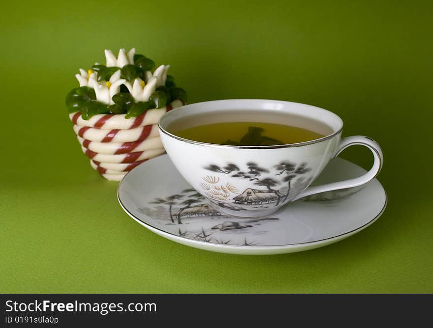 Tea cup and jellies close-up isolated