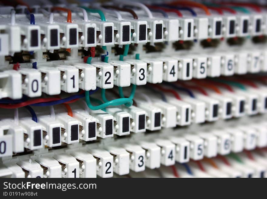 Image of white electronic connectors with pluged, colored wires and black numeric marks