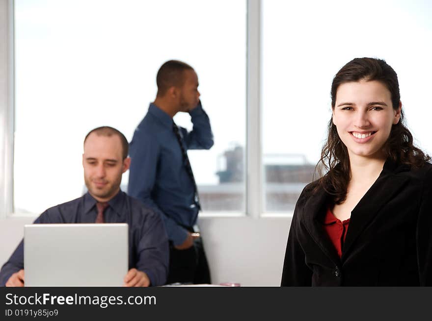 Three business associates with a grey laptop. Three business associates with a grey laptop