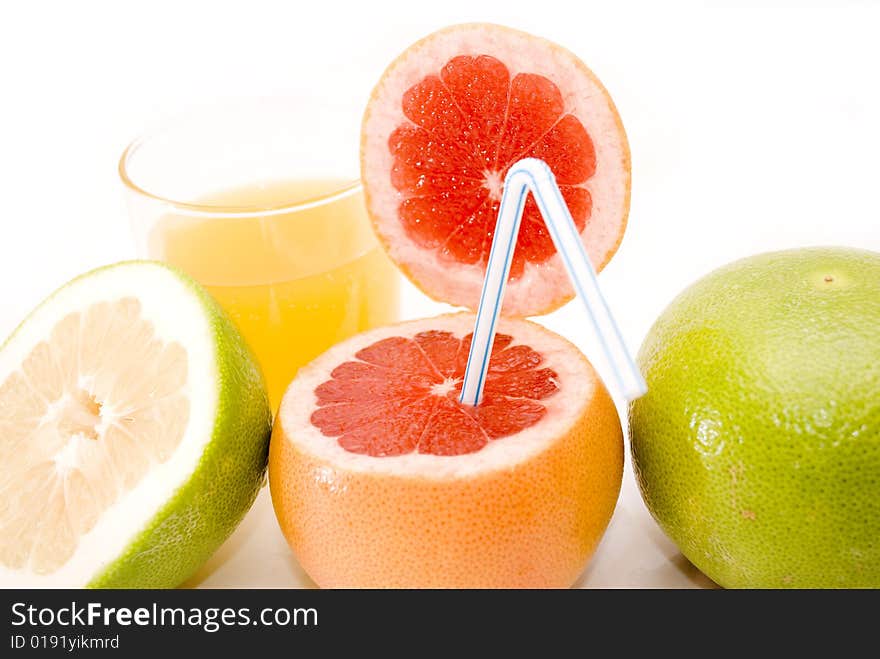 Citrus Fruits - res and green grapefruits, and glass of orange juice isolated on white