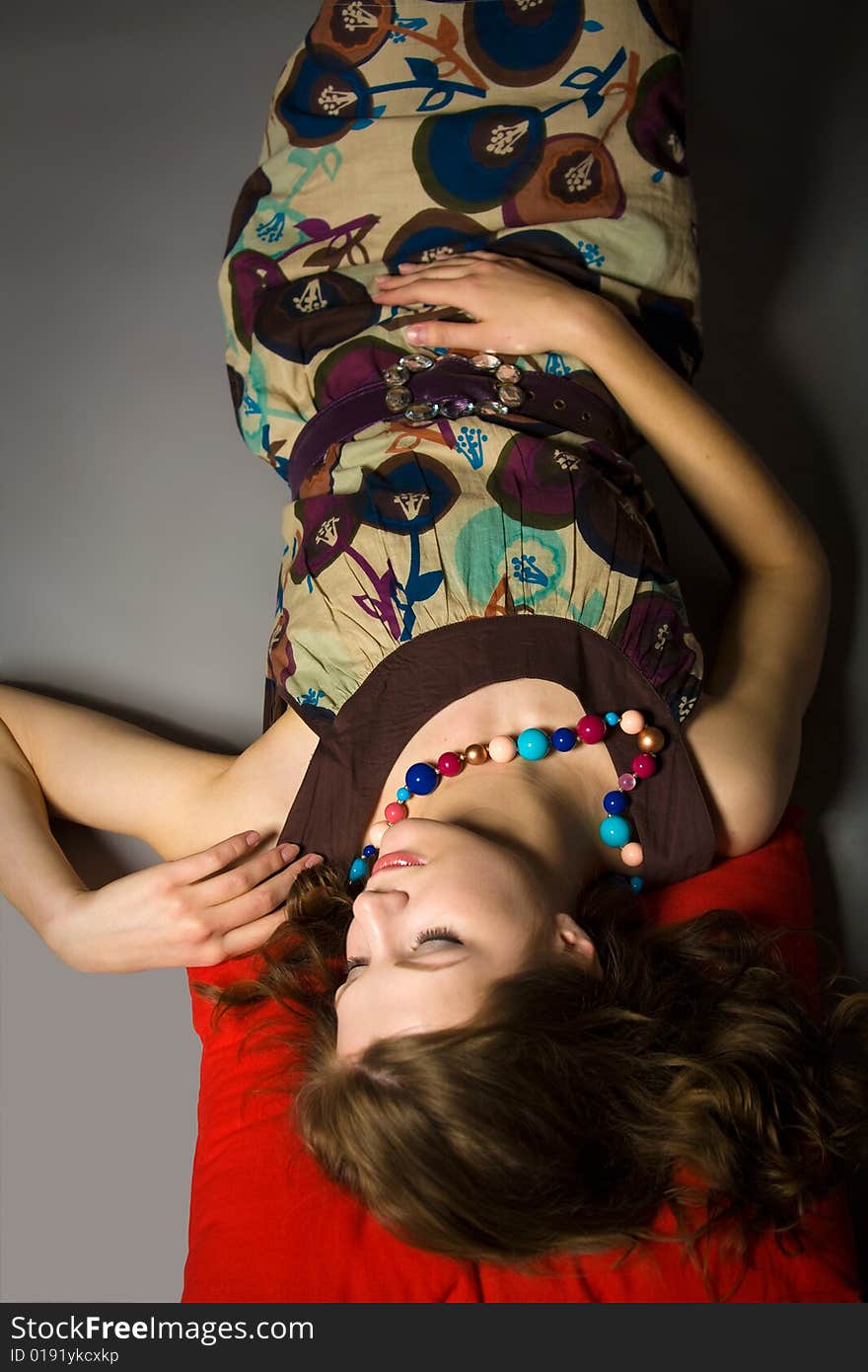 Girl Sleeping in Dress on red pillow