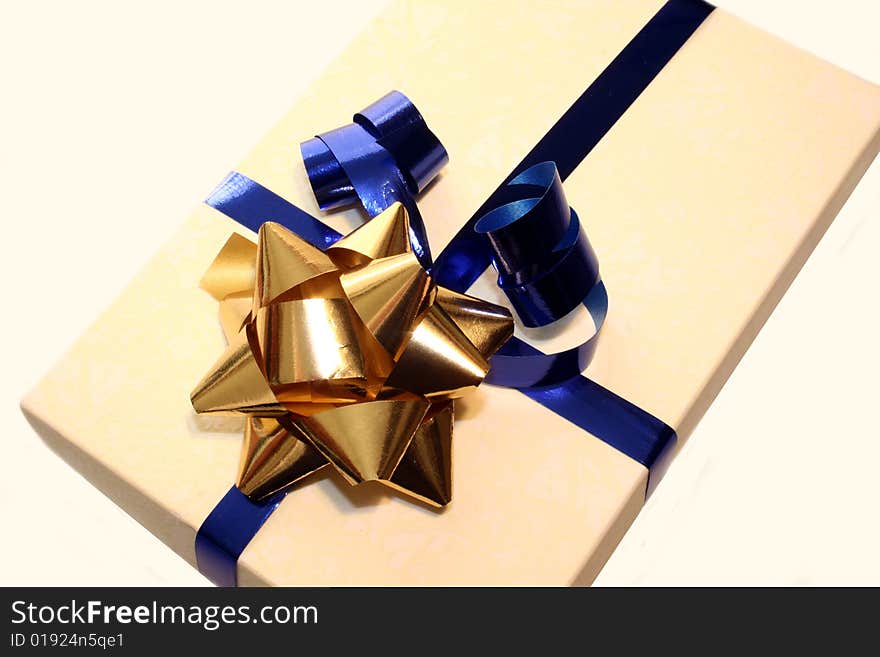 Colored gift box with blue and gold ribbon