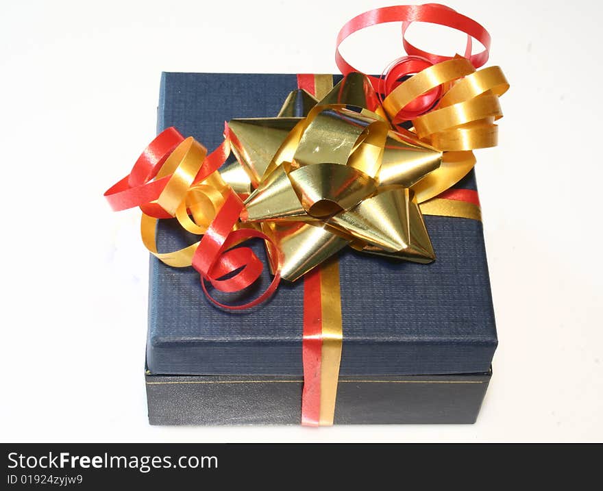 Colored gift box with red and gold ribbon