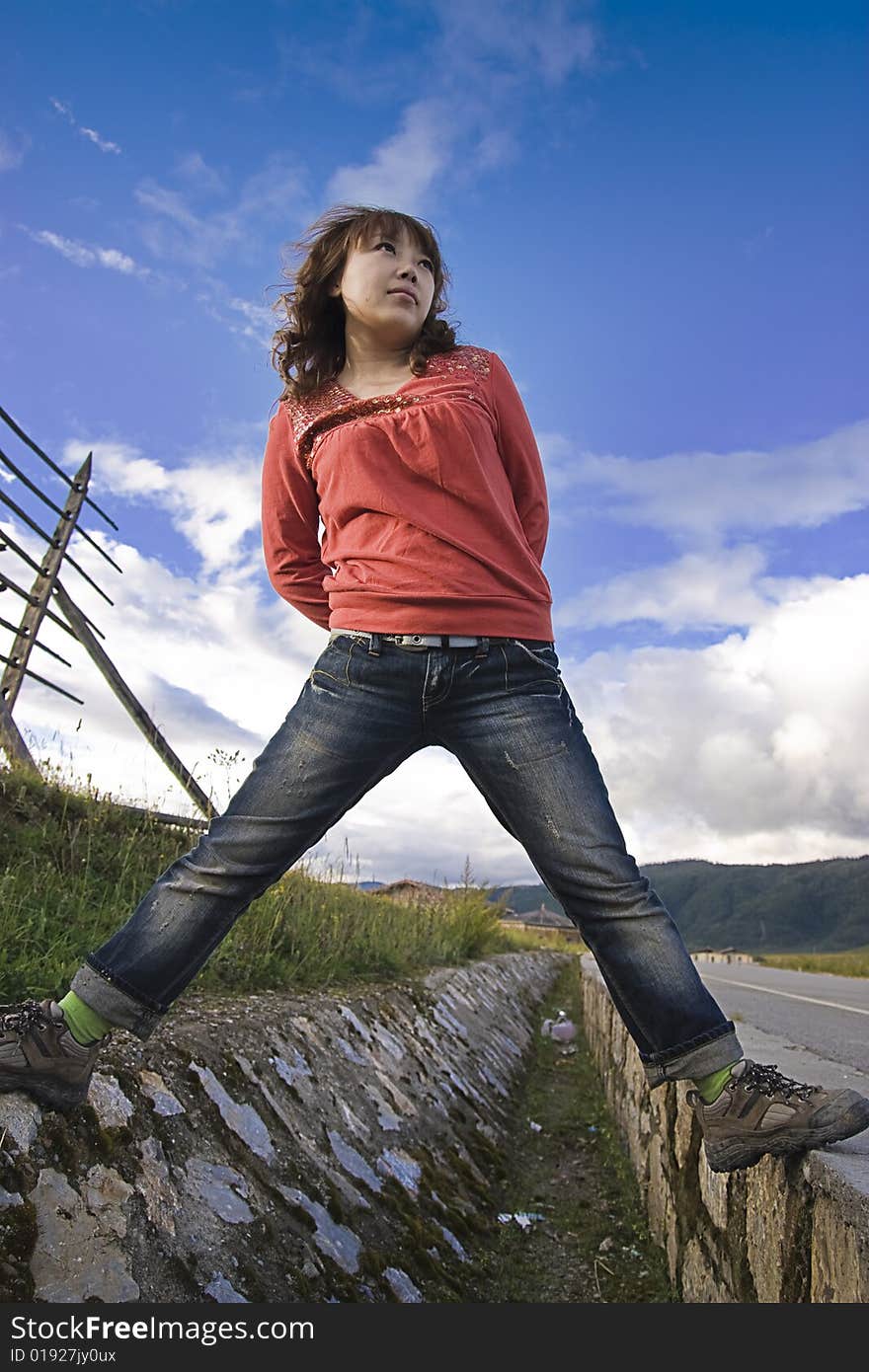 A girl stand on the road