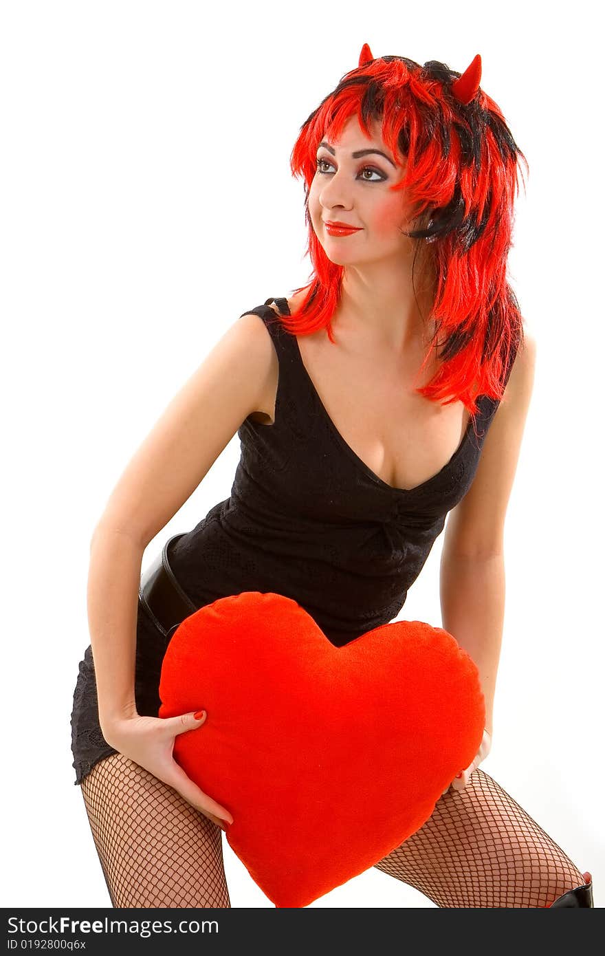 Sexy devil woman and red heart isolated on the white background