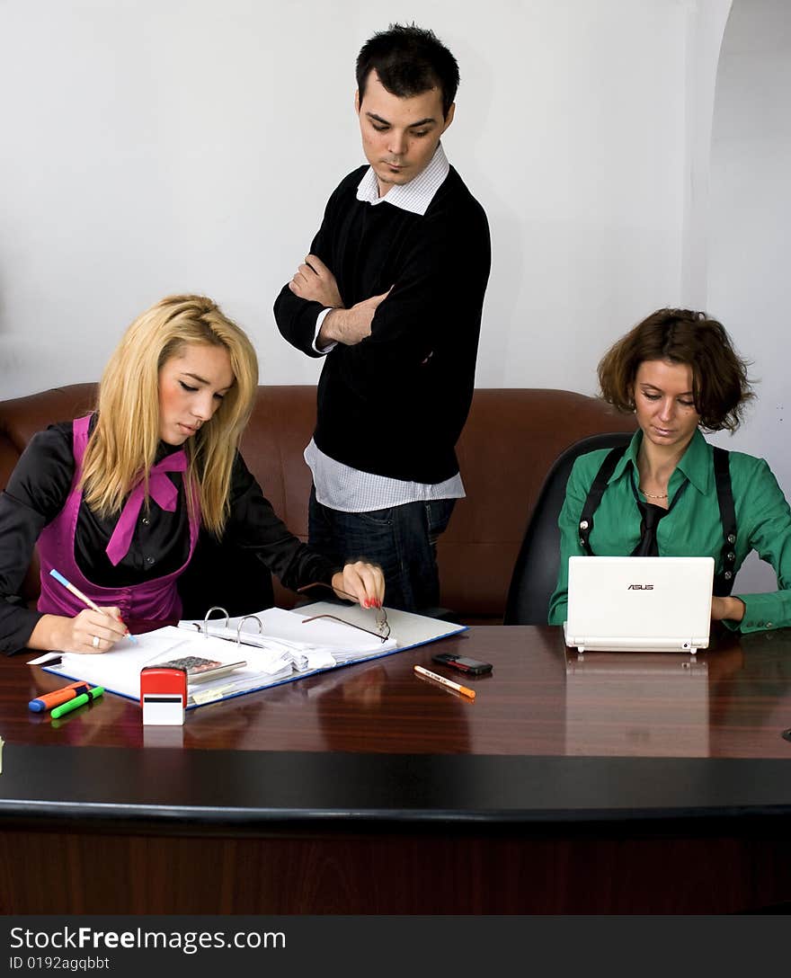 Successful business team working over a laptop computer and documents