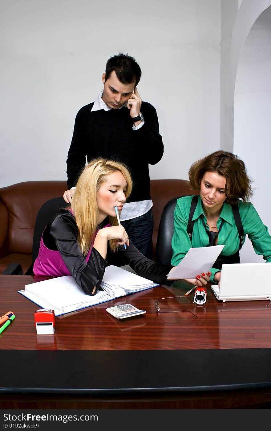 Successful business team working over a laptop computer and documents