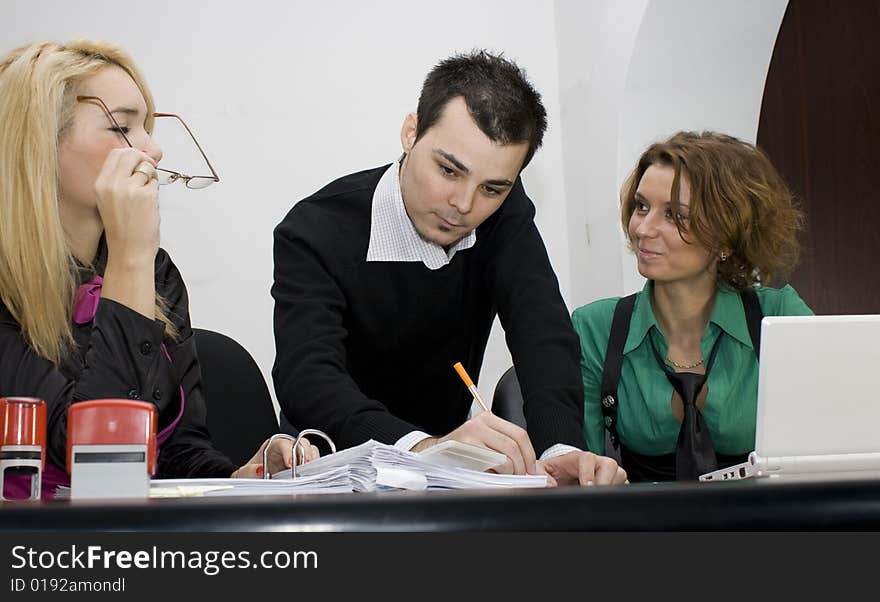 Successful business team working over a laptop computer and documents