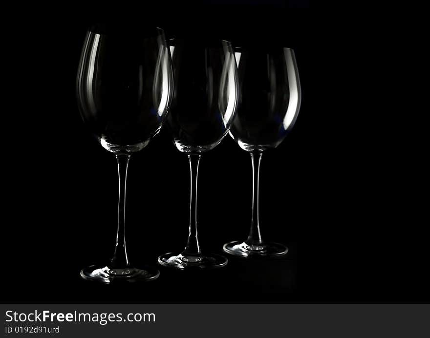 Three wine glasses on a dark background