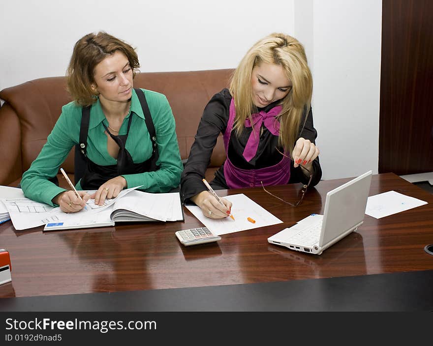 Successful business team working over a laptop and documents