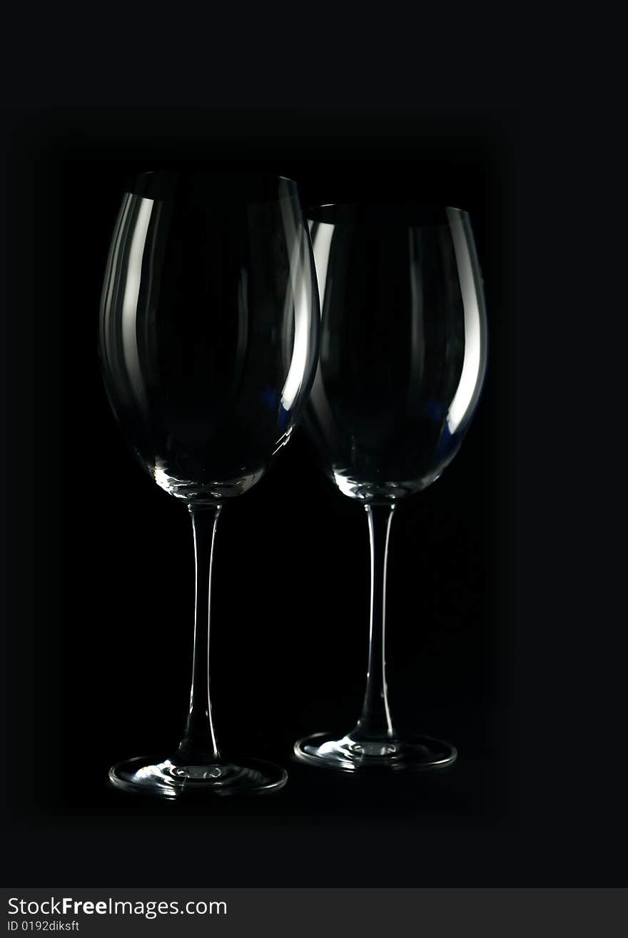 Two wine glasses on a dark background