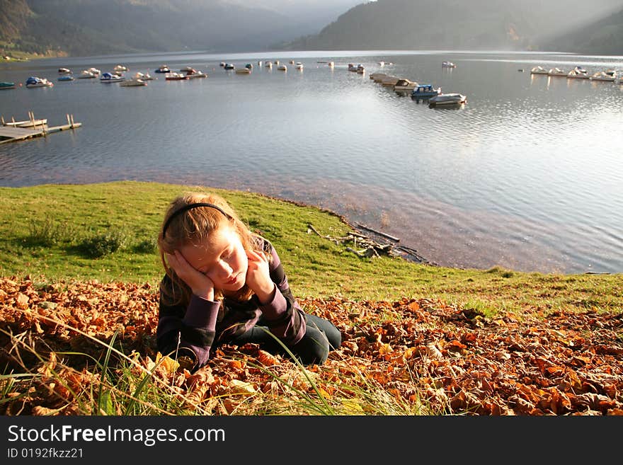 View of the lake Wägital in Swiss Alps with a girl in the evenings sunbeams. View of the lake Wägital in Swiss Alps with a girl in the evenings sunbeams