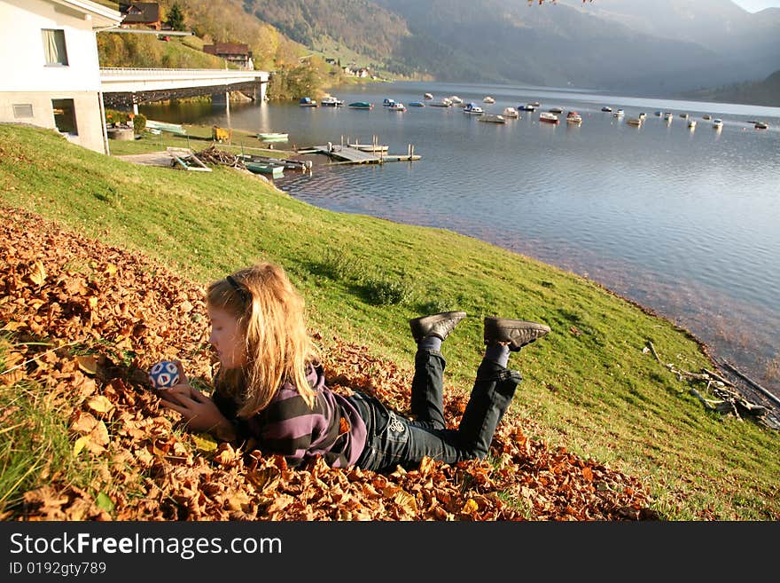 View of the lake Wägital in Swiss Alps with a girl in the evenings sunbeams. View of the lake Wägital in Swiss Alps with a girl in the evenings sunbeams