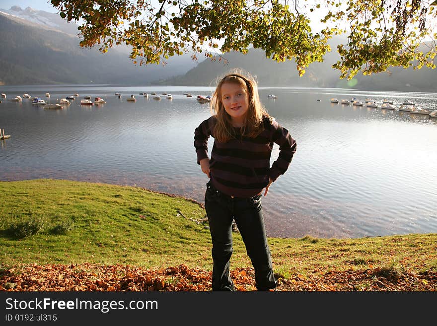 View of the lake Wägital in Swiss Alps with a girl in the evenings sunbeams. View of the lake Wägital in Swiss Alps with a girl in the evenings sunbeams