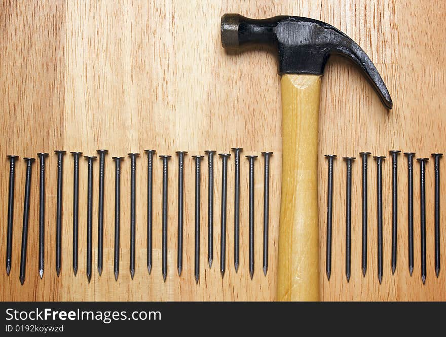 Hammer and Nails Abstract on Wood Background.