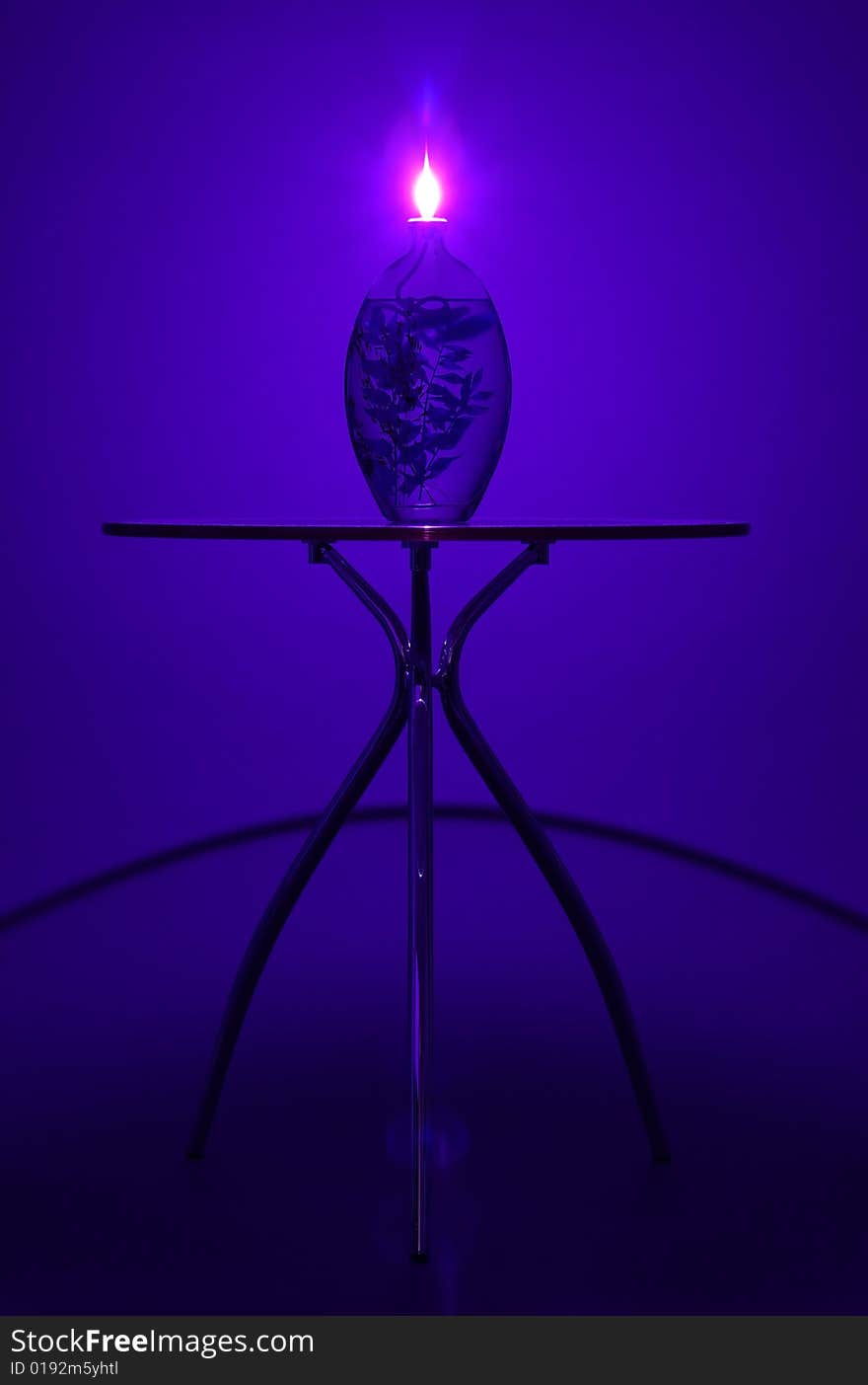 A photograph of a candle on top of a small table, casting interesting shadows. A photograph of a candle on top of a small table, casting interesting shadows.