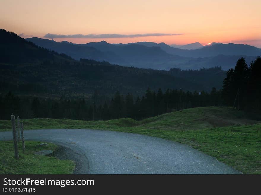 Misty shadows hills with colorful sunrise sky. Misty shadows hills with colorful sunrise sky