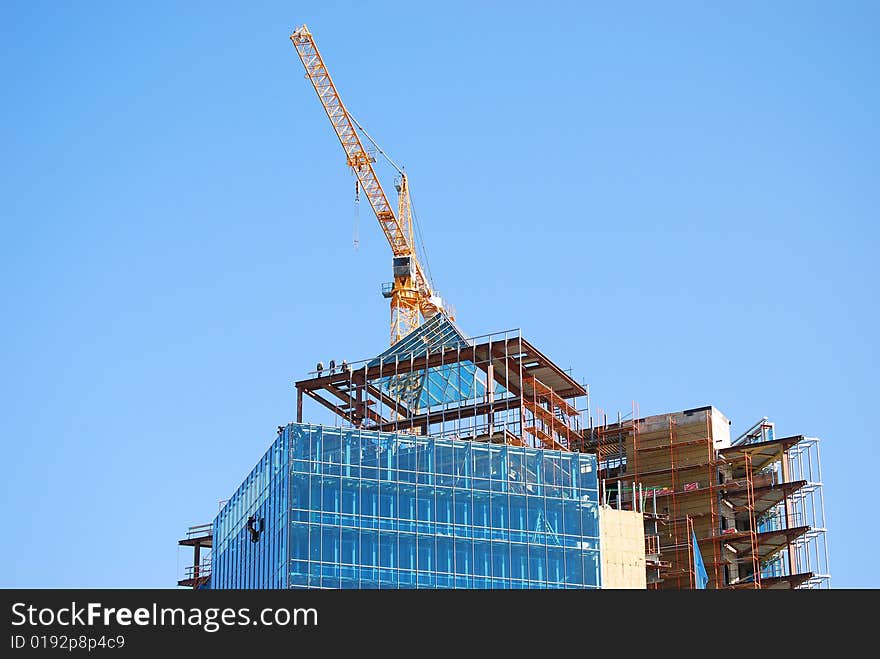 Building construction with crane and people on roof working. Building construction with crane and people on roof working