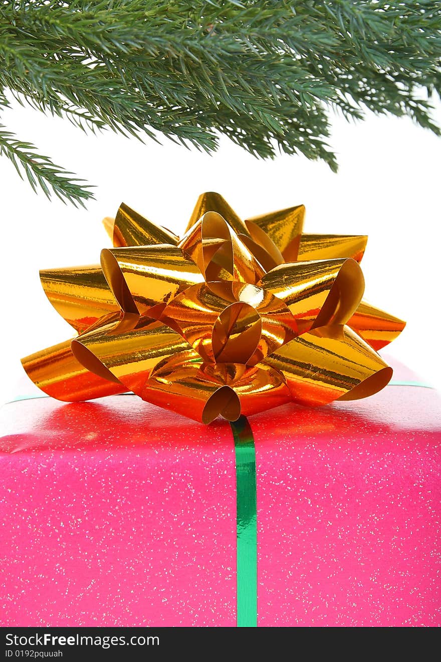 Gift box with golden bow under christmas tree. Gift box with golden bow under christmas tree