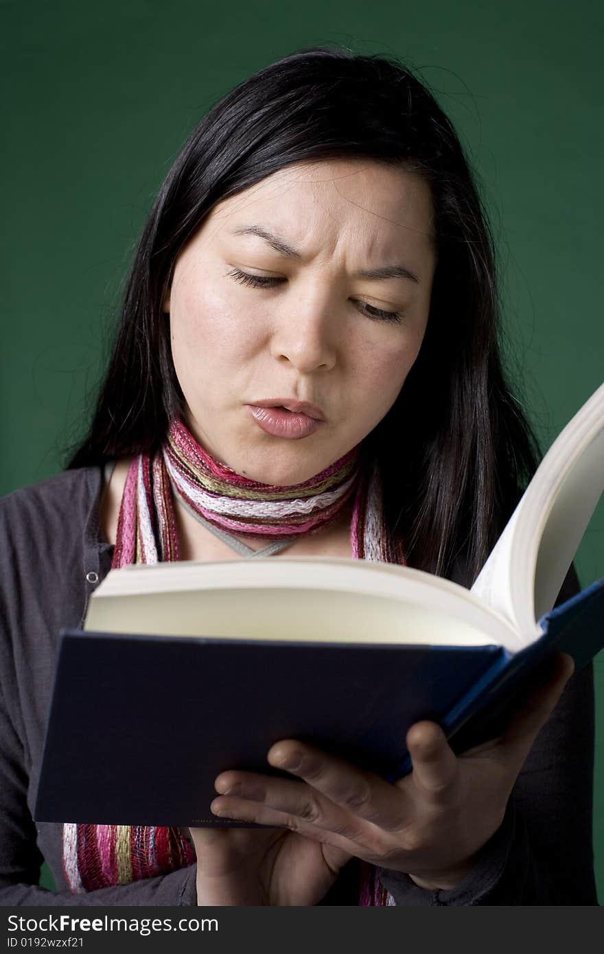 Young Asian woman reads a book