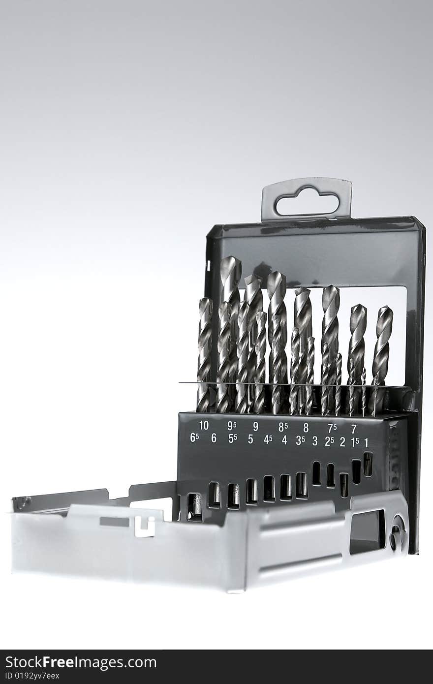 Set of drill bits over gray background