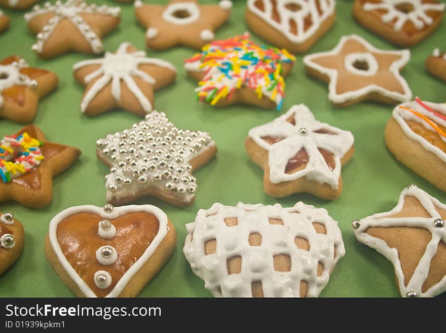 Decorated star and heart cookies on green paper. Decorated star and heart cookies on green paper