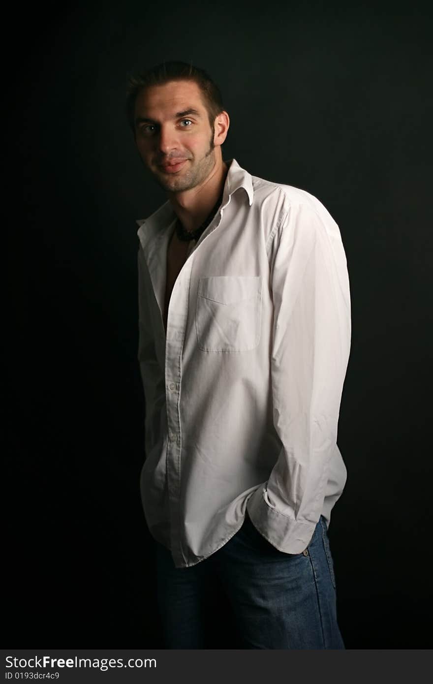 Young man in a white shirt on a black background