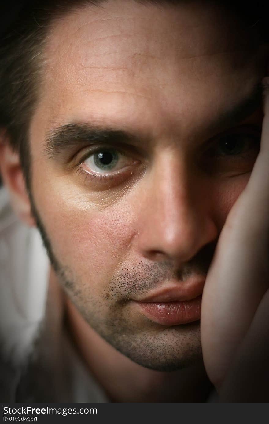 Young man in a white shirt on a black background