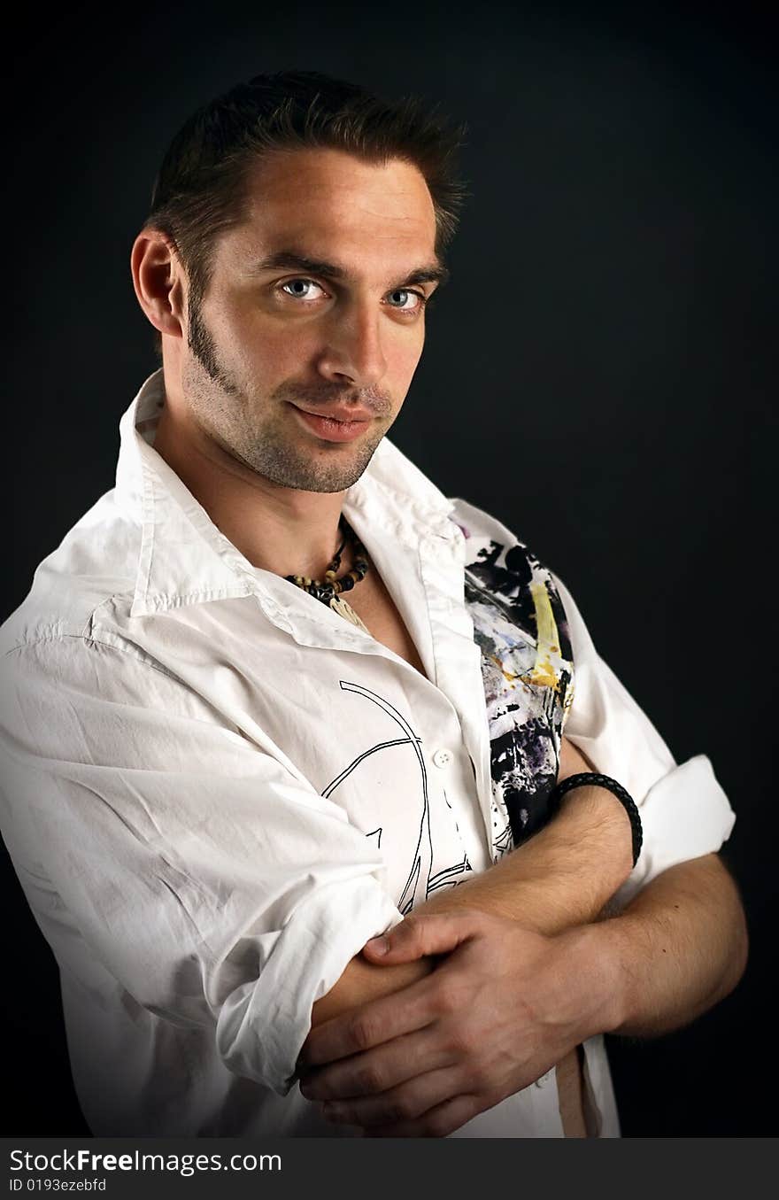 Young man in a white shirt on a black background